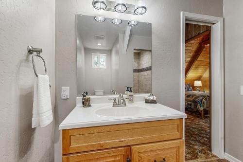 a bathroom with a sink and a mirror at The Kachina Cabin in Mountainaire