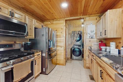 a kitchen with wooden cabinets and a stove at Starry Skies and Fireflies in Ellijay