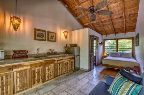 a kitchen with a couch and a ceiling fan at Camp Bay Lodge in Camp Bay