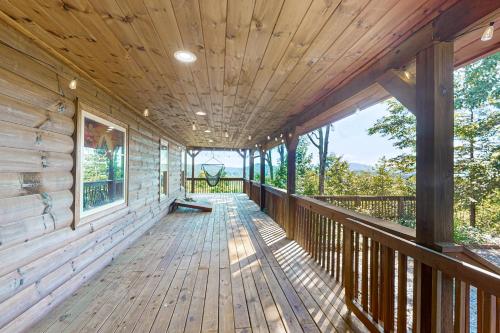 a large wooden deck with a large window at Starry Skies and Fireflies in Ellijay