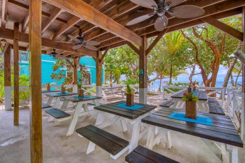 a group of picnic tables in a pavilion on the beach at Camp Bay Lodge in Camp Bay