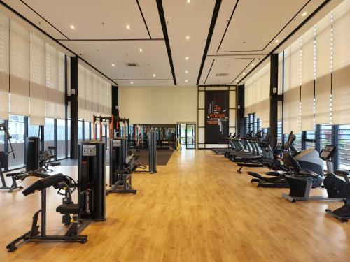 a gym with a lot of treadmills and machines at Mossaz Dream Suite in Petaling Jaya