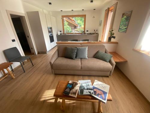 a living room with a couch and a table at Alaska House Suite Bering - sauna and relax in Trento