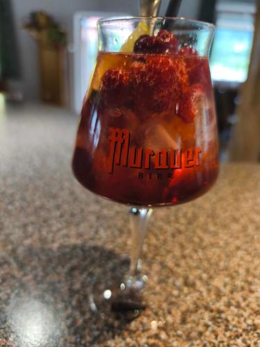 a drink in a wine glass on a counter at Landcafe Kauder in Stadl an der Mur