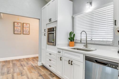 a kitchen with white cabinets and a sink at Fishing Paradise Lake Poinsett Home with Deck! in Cocoa