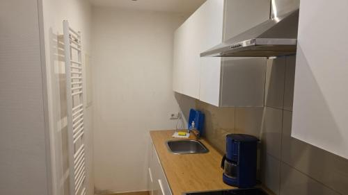 a small kitchen with a sink and a counter at Sweet Ferien & Monteurs Appartement in Wuppertal
