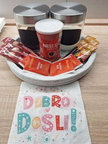 a tray with two cups of soda and a plate of food at Apartman ZID in Smederevska Palanka