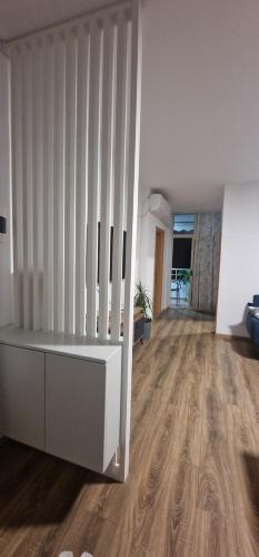 a living room with white walls and wooden floors at Comfortable holiday apartament in Golem
