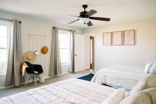 a bedroom with two beds and a ceiling fan at The Estate on 68 AND Pet Friendly in Springfield