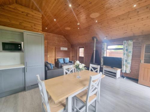 a dining room with a table and a couch at Oak 9 Hot Tub in Garton