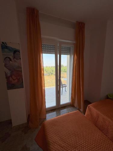 a bedroom with a window with a view of a patio at La casa di Nana' 1 in Casalbordino
