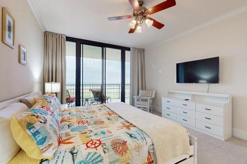 a bedroom with a bed and a flat screen tv at Holiday Isle 618 in Dauphin Island