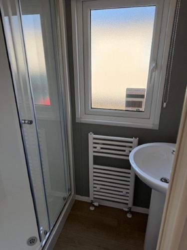 a bathroom with a shower and a sink and a window at Modern 8 Berth Caravan With Near To Scratby Beach At Cali Cliffs Ref 50010Ae in Great Yarmouth