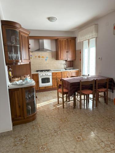 a kitchen with a wooden table and a dining room at La casa di Nana' 1 in Casalbordino