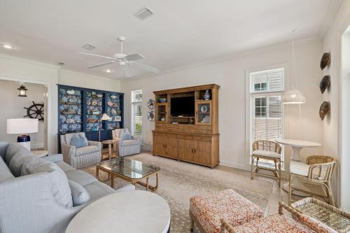 a living room with a couch and a tv at Always On My Mind by 30A Escapes in Seacrest