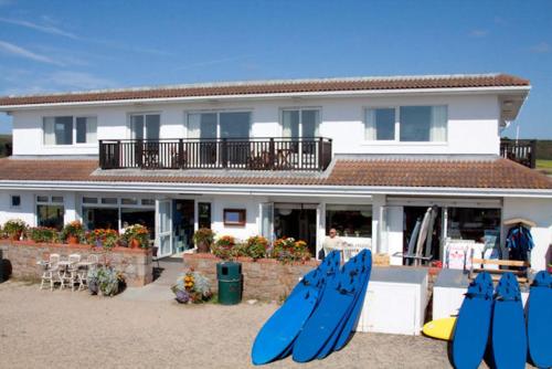 a group of blue surfboards in front of a building at Discovery Bay in St Ouen's