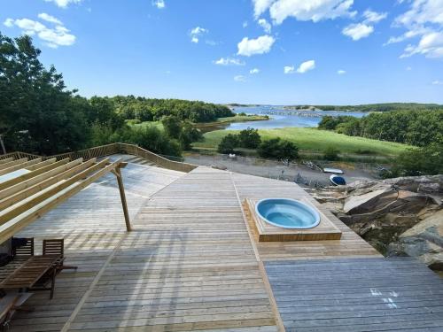 a wooden deck with a hot tub on it at Seaside Panorama Villa in Gothenburg