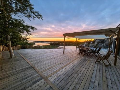 a wooden deck with a table and chairs on it at Seaside Panorama Villa in Gothenburg