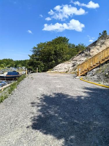 a road with a bridge next to a river at Seaside Panorama Villa in Gothenburg