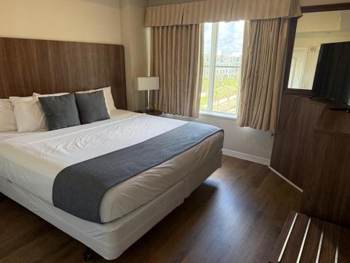 a bedroom with a large bed and a window at The Point Hotel & Suites - 503 Luxury - Pool view - Close to Universal in Orlando