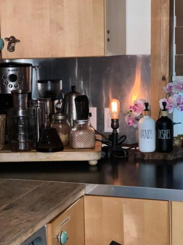 a kitchen with a counter top with a stove top oven at PRIVATE HOUSE and private HOT TUB Seas The Day Pets BBQ Beaches Artists Studio Lower Gibsons The Bay in Gibsons