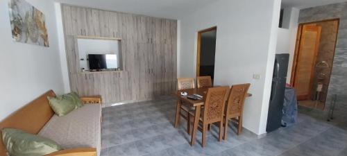 a living room with a couch and a table at Studio SARAH in Tabarka