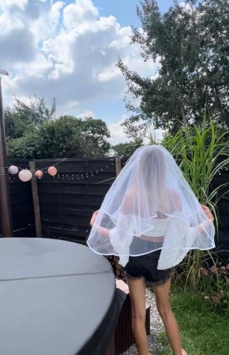 a woman in a plastic veil standing next to a table at Samosiejka SPA Słońsko in Słońsko