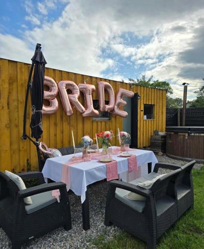 a table with an umbrella and a sign that reads exit at Samosiejka SPA Słońsko in Słońsko
