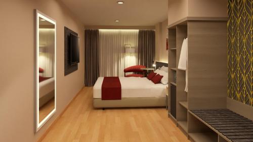 a hotel room with a bed and a desk at Ramada Suites by Wyndham Asuncion Aeropuerto in Asuncion