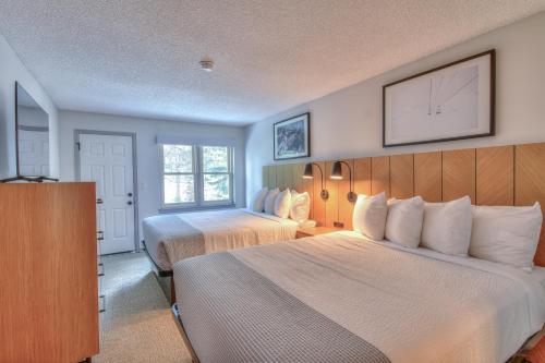 a hotel room with two beds and a window at Wedgewood Lodge in Breckenridge