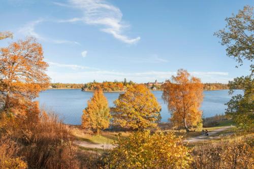 a view of a lake in the fall at Hagastrand, Autograph Collection in Solna
