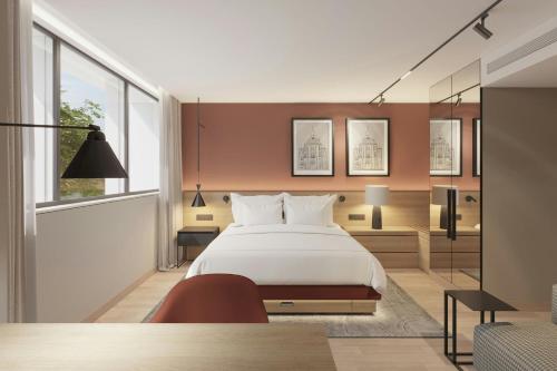 a bedroom with a large white bed and a window at Residence Inn by Marriott Lisbon in Lisbon