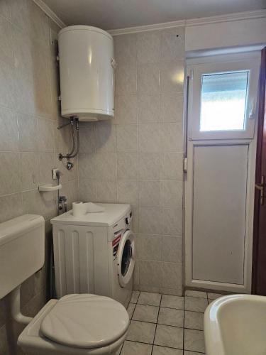 a small bathroom with a toilet and a sink at Apartmani Štefica in Dramalj