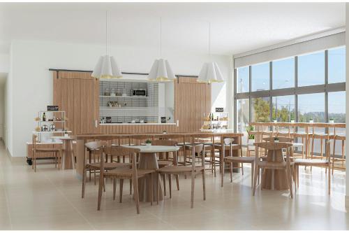 a dining room with wooden tables and chairs at Element Opelika Auburn in Opelika