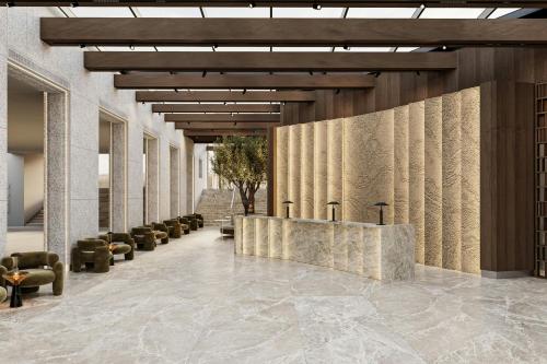 a lobby with a reception desk and chairs at AC Hotel by Marriott Vilnius in Vilnius