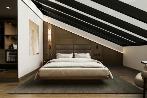 a bedroom with a large bed with a striped ceiling at AC Hotel by Marriott Vilnius in Vilnius