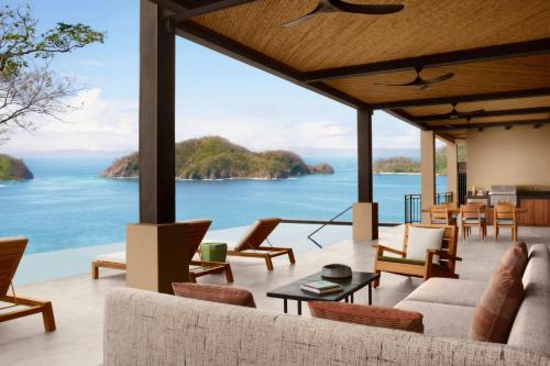 a living room with a view of the ocean at Nekajui, a Ritz-Carlton Reserve Residences in Liberia