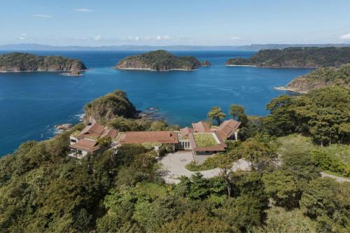 an aerial view of a house on a island in the water at Nekajui, a Ritz-Carlton Reserve Residences in Liberia