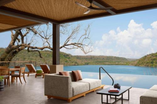 a living room with a view of a lake at Nekajui, a Ritz-Carlton Reserve Residences in Liberia