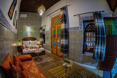 a room with a bedroom with a bed and a window at Riad Hikaya - Fes Story in Fès