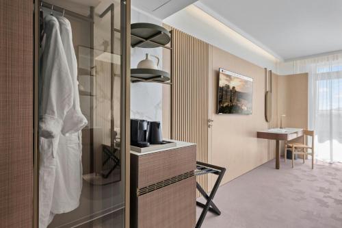 a bathroom with a shower and a dressing room at The Landmark Nicosia, Autograph Collection in Nicosia