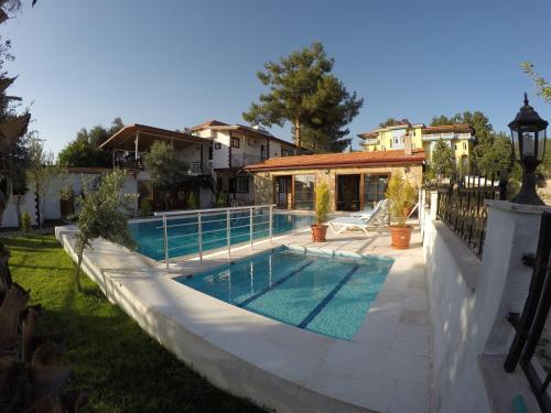 a swimming pool in the backyard of a house at Pınar Vintage House in Pamukkale