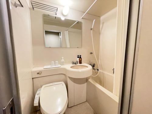 a small bathroom with a toilet and a sink at Smile Hotel Yonago - Vacation STAY 61085v in Yonago