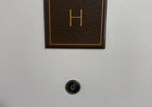 a clock on a white wall with aperature at The Point Hotel & Suites - 705H Luxury - Pool view - Close to Universal in Orlando