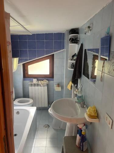 a bathroom with a sink and a toilet and a tub at Attico da Luisa in Camigliatello Silano