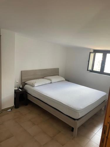 a bed with two pillows on it in a room at Attico da Luisa in Camigliatello Silano