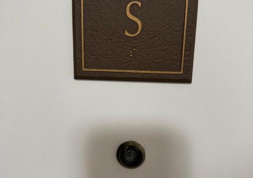 a clock hanging on a white wall with at The Point Hotel & Suites - 705S Luxury - Pool view - Close to Universal in Orlando