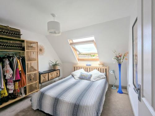 a bedroom with a bed and a window at Airy coastal courtyard house in Parkstone