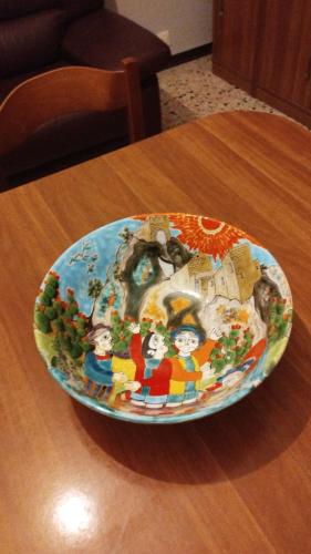 a plate on top of a wooden table at Nino's House in Sperlinga