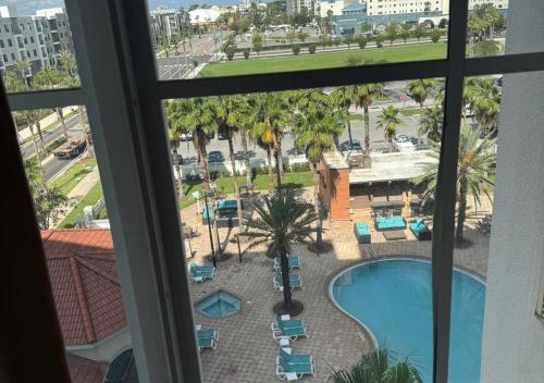 a view of a pool from a hotel room window at The Point Hotel Apartment 603 Near to Universal in Orlando